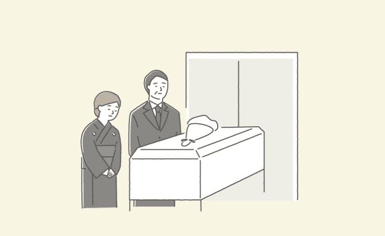 火葬炉にお棺が入るところを見送る親族